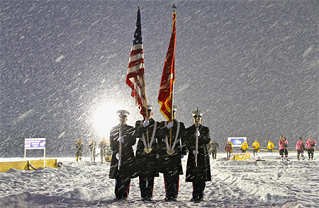 Marines present the colors during a snowstorm. 