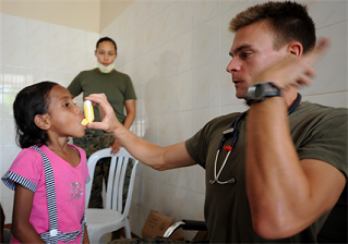 A physician provides care to a child.