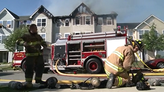 Firefighters respond to a house fire in this image.