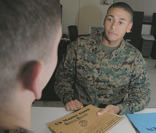 A Marine holds a folder with documents.