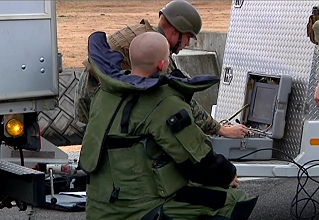 Technicians evaluate a suspicious package in this image.